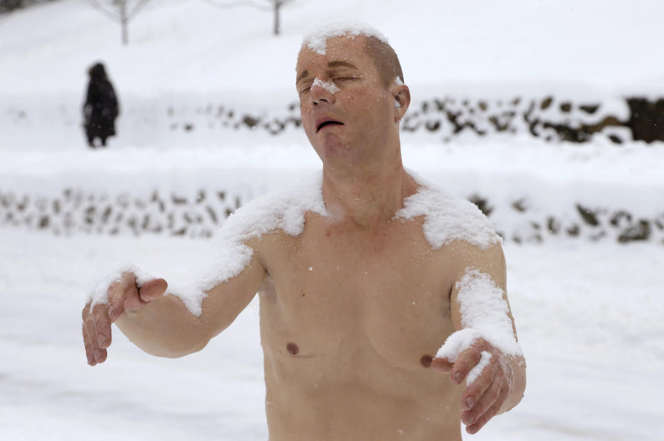 A statue of a man sleepwalking in his underpants is surrounded by snow on the campus of Wellesley College, in Wellesley, Mass., Wednesday, Feb. 5, 2014. The sculpture entitled "Sleepwalker" is part of an exhibit by sculptor Tony Matelli at the college's Davis Museum. (AP Photo/Steven Senne)