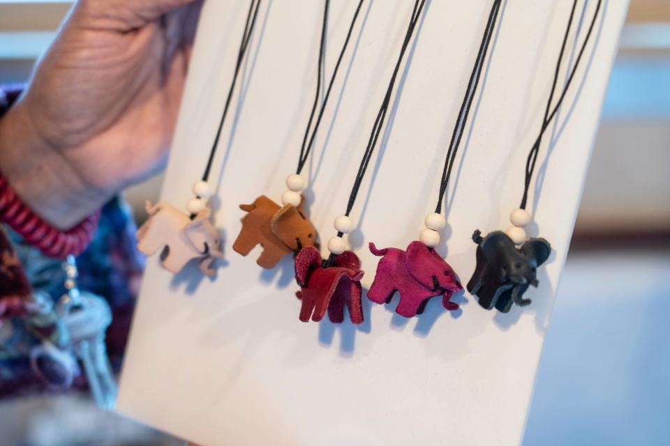 Hand made leather elephant necklaces from South Africa are shown as a gift item for holiday shoppers at the space for Love Travels Imports in the Downtown Detroit Markets located at Cadillac Square in downtown Detroit on Wednesday, November 30, 2022.