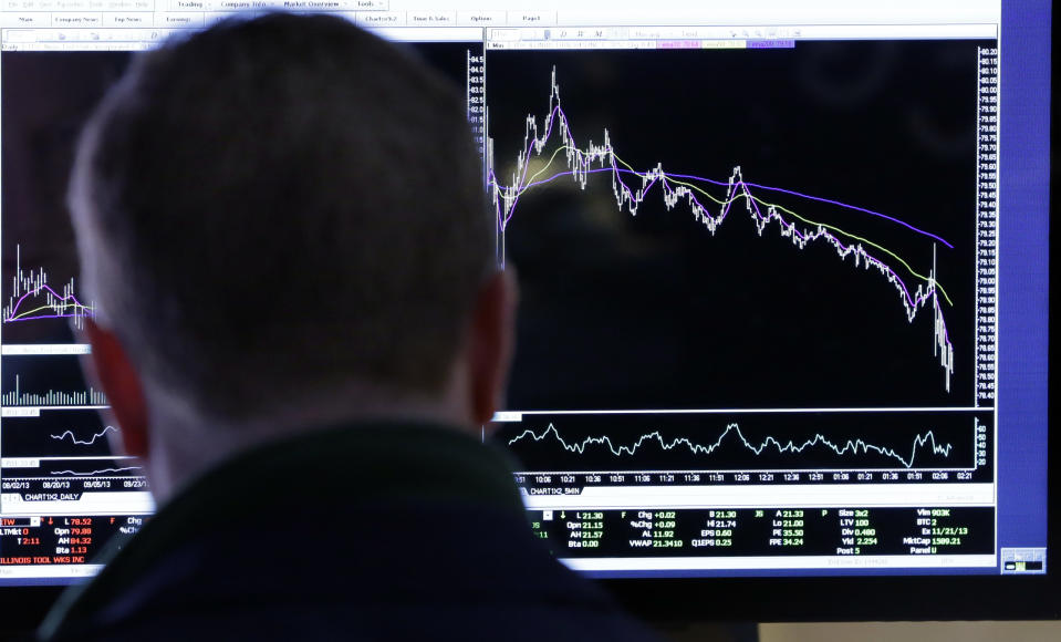 A specialist works at his post on the floor of the New York Stock Exchange Wednesday, Jan. 29, 2014. The U.S. stock market stumbled briefly on Wednesday after the Federal Reserve decided to further reduce its economic stimulus. (AP Photo/Richard Drew)