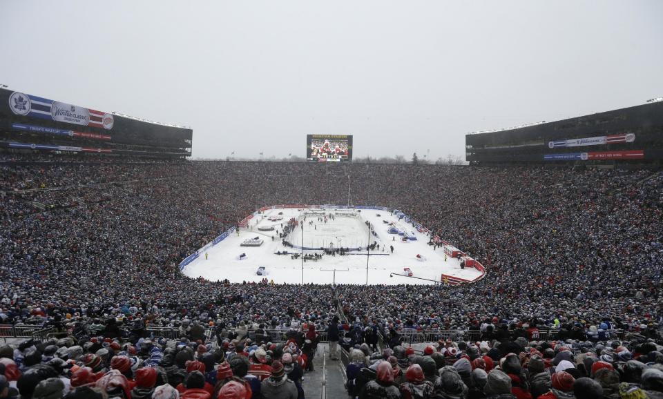 The Detroit Red Wings and the Toronto Maple Leafs skate during the third period of the Winter Classic outdoor NHL hockey game at Michigan Stadium in Ann Arbor, Mich., Wednesday, Jan. 1, 2014. (AP Photo/Carlos Osorio)