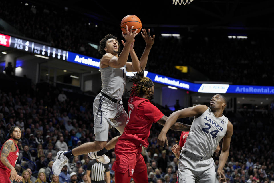 Xavier guard Desmond Claude (1) shoots against Houston's Ja'Vier Francis (5) during the first half of an NCAA college basketball game Friday, Dec. 1, 2023, in Cincinnati. (AP Photo/Jeff Dean)