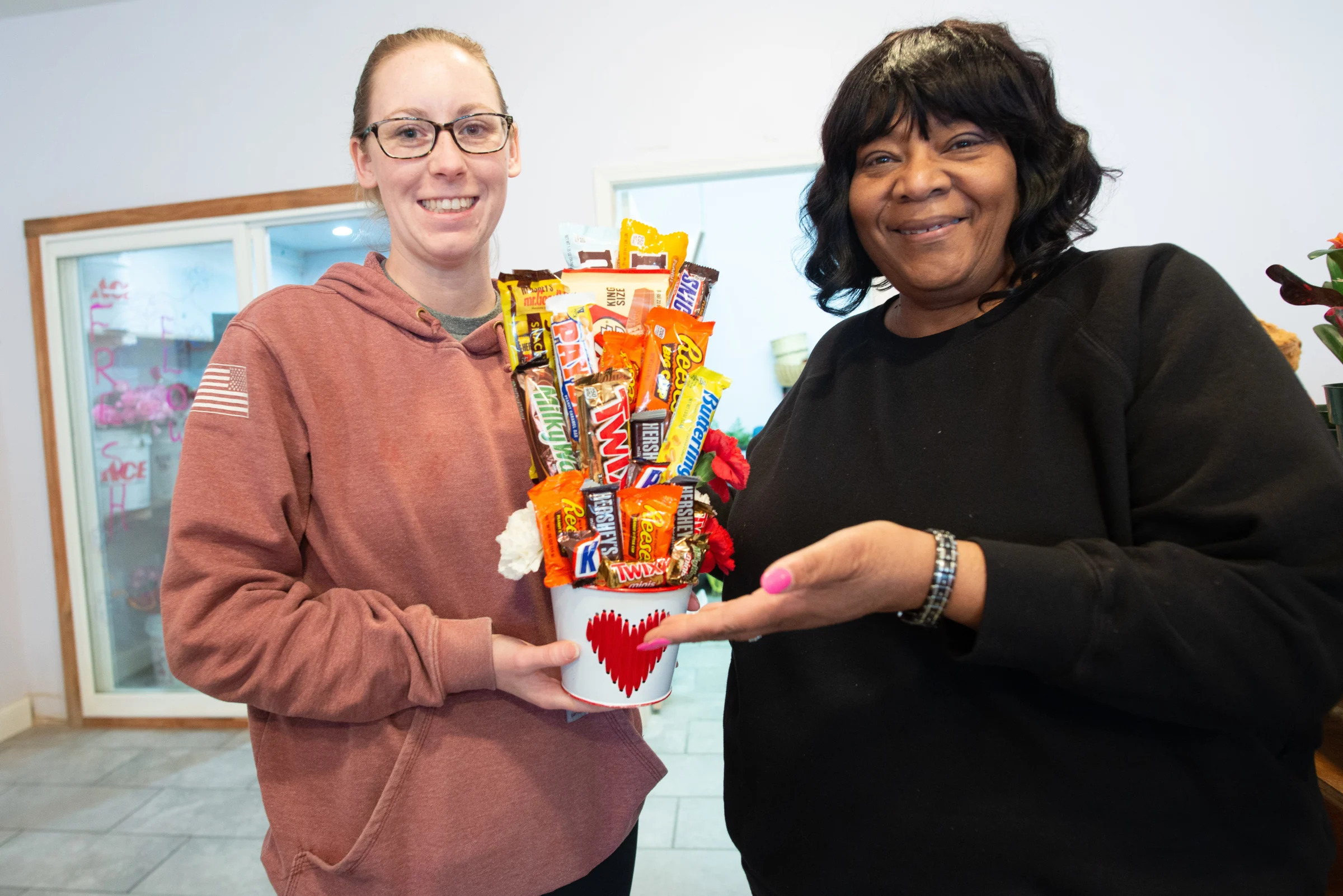 A bouquet of candy bars and flowers are shown by Shirley Wright, right, owner of Breezy Designs by Shirls, and employee Kassie Barnhart.