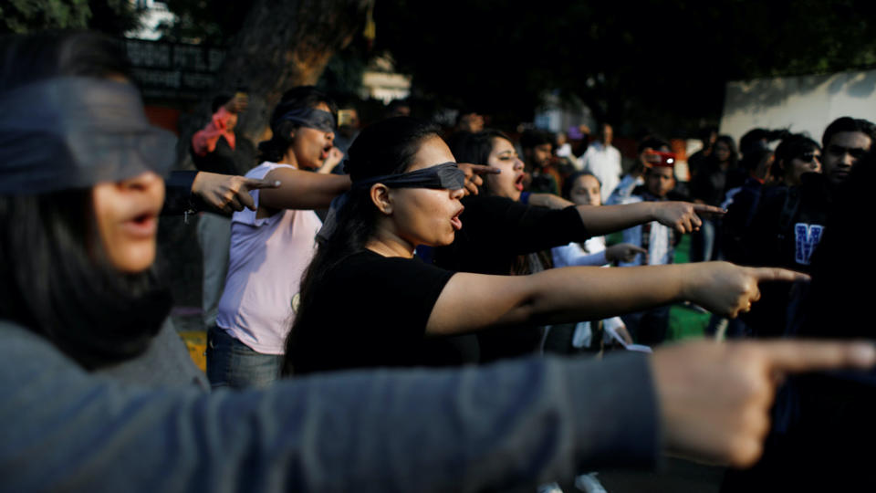 Protestors wearing blindfolds take part in a protest in India