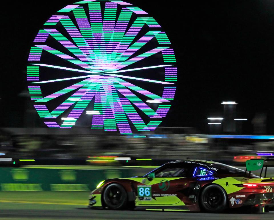 The No. 86 Porsche 911 GT3 R heads through the horseshoe early Sunday during the Rolex 24 at Daytona International Speedway. An inflex of race fans generated big business this past weekend for area hoteliers, who are expecting another big boost from the Daytona 500 on Feb. 18.