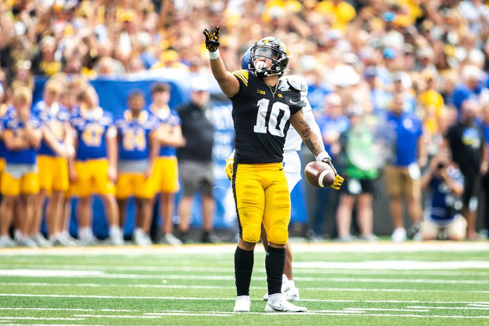 Former Iowa wide receiver Arland Bruce IV gestures for a first down during a 2022 game at Kinnick Stadium.