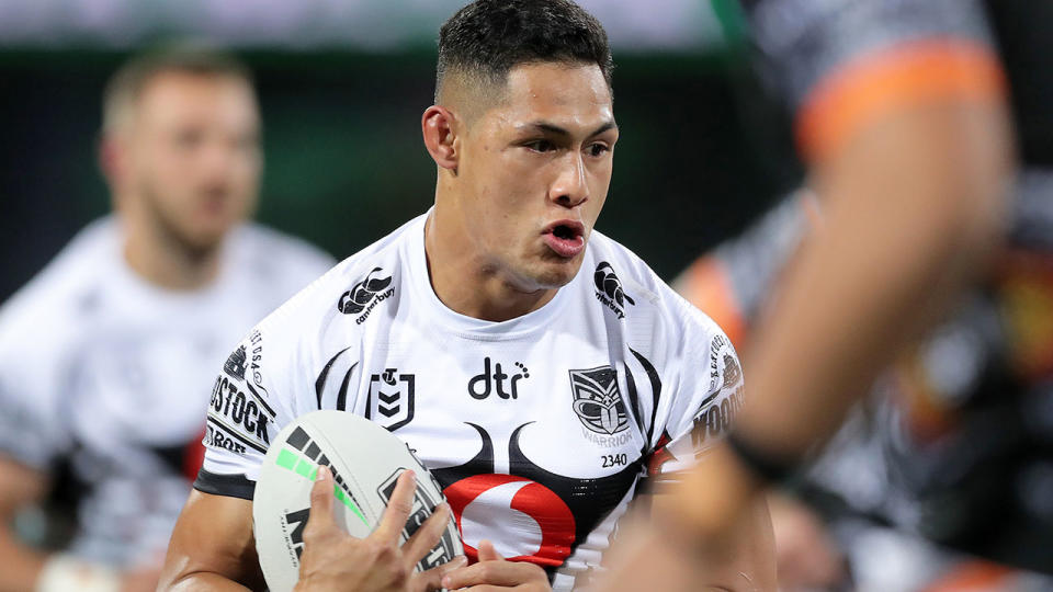 Pictured here, Roger Tuivasa-Sheck carries the ball for the Warriors during an NRL match.