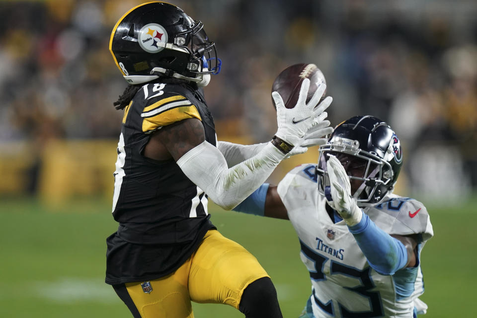 Pittsburgh Steelers wide receiver Diontae Johnson (18) makes a catch past Tennessee Titans cornerback Tre Avery (23) during the second half of an NFL football game Thursday, Nov. 2, 2023, in Pittsburgh. (AP Photo/Matt Freed)