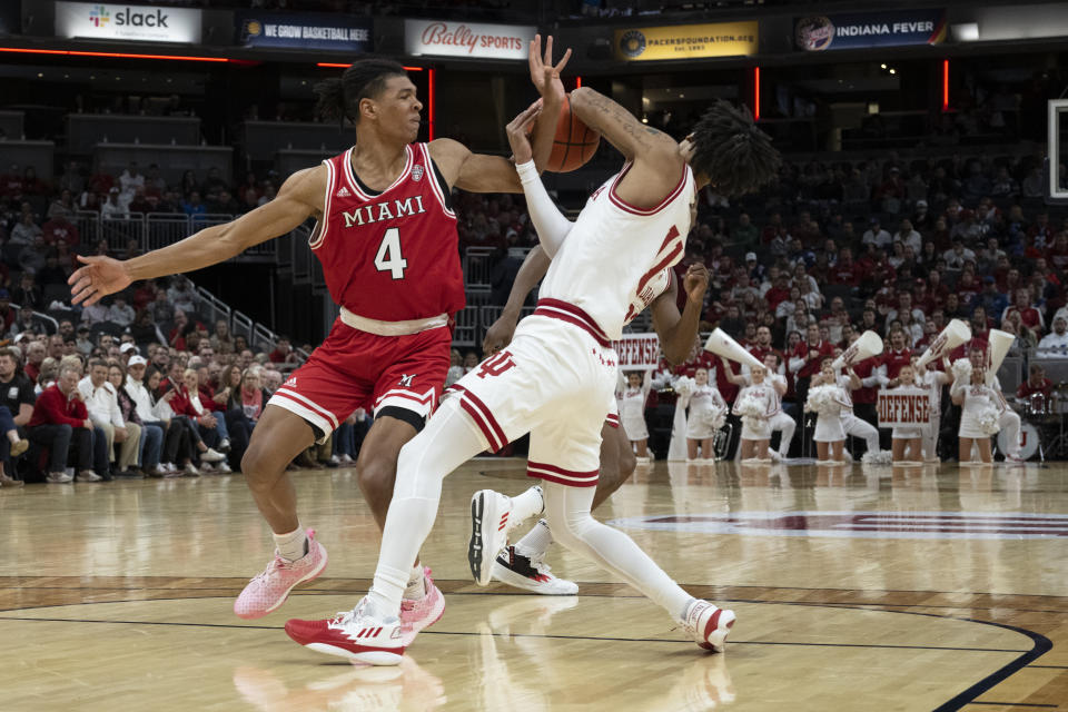 Indiana guard CJ Gunn and Miami (Ohio) guard Bryson Tatum (4) fight for a ball during the first half of an NCAA college basketball game, Sunday, Nov. 20, 2022, in Indianapolis. (AP Photo/Marc Lebryk)