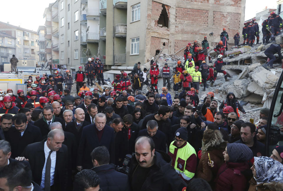 Turkey's President Recep Tayyip Erdogan, centre left, visits Elazig, eastern Turkey, site of Friday's earthquake, Saturday, Jan. 25, 2020. Rescuers continued searching for people buried under the rubble of collapsed buildings while emergency workers and security forces distributed tents, beds and blankets in the affected areas. Mosques, schools, sports halls and student dormitories were opened for hundreds who left their homes after the quake. (Presidential Press Service via AP, Pool)