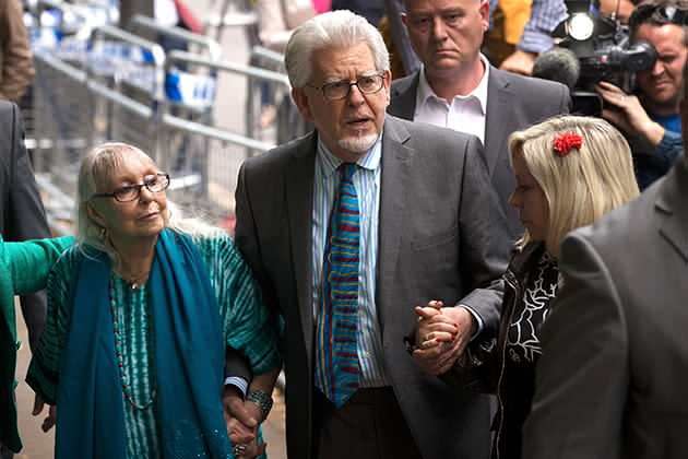 Rolf Harris leaves court holding the hands of his wife Alwen Hughes (left) and daughter Bindi Harris (right) of 12 indecent assault charges. Photo: Getty