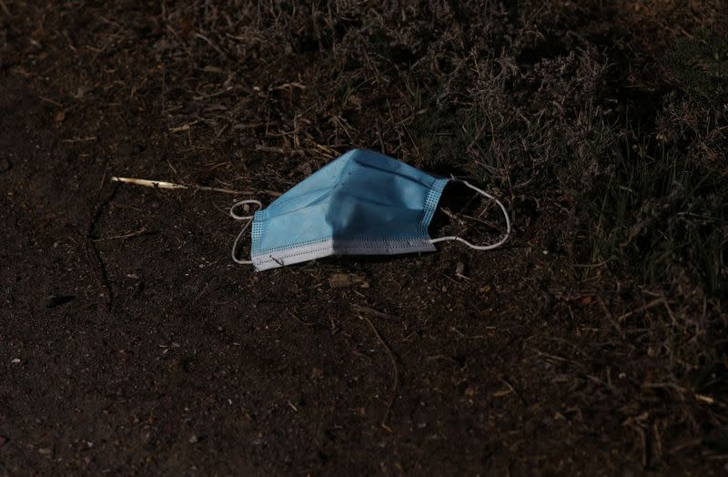 A face mask lays on the road outside JBS USA meat packing plant