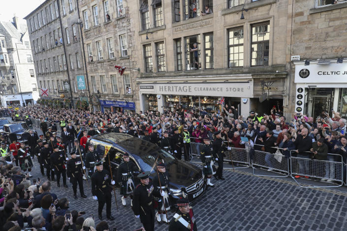The procession with the coffin of Queen Elizabeth II, followed by King Charles III, Princess Anne, Prince Edward and Prince Andrew, heads up the Royal Mile to St Giles' Cathedral in Edinburgh, Monday, Sept. 12, 2022. Britain's longest-reigning monarch who was a rock of stability across much of a turbulent century, died Thursday Sept. 8, 2022, after 70 years on the throne. She was 96. (AP Photo/Scott Heppell)