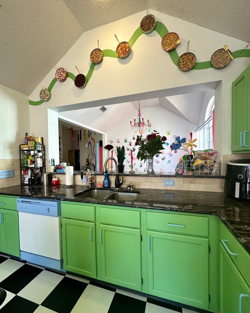 Kitchen with black and white floor and bright green cabinets