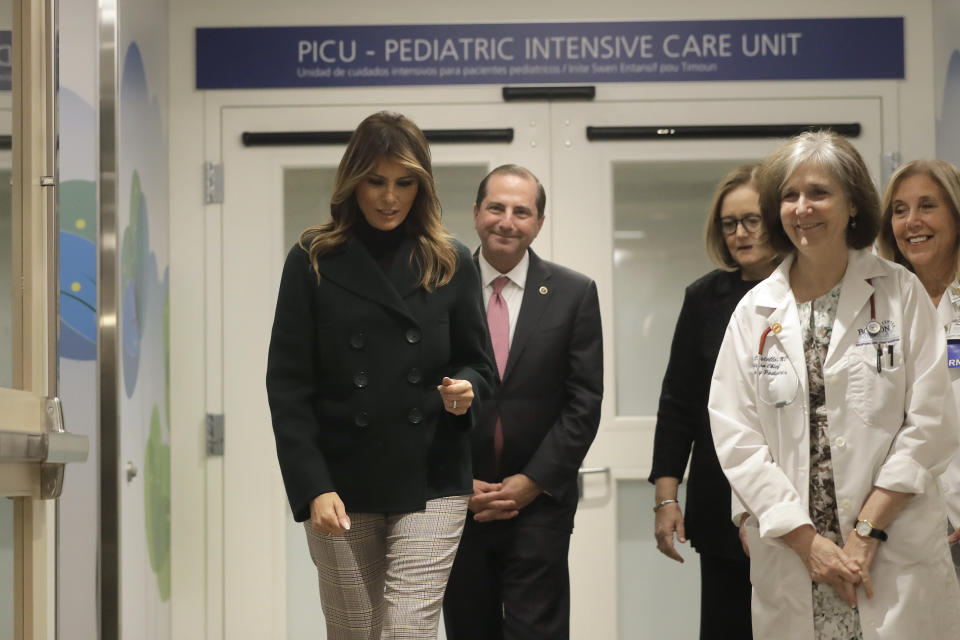 First lady Melania Trump, left, walks with pediatrician Eileen Costello, front right, and U.S. Secretary of Health and Human Services Alex Azar, behind center left, during a visit to Boston Medical Center, in Boston, Wednesday, Nov. 6, 2019. The visit, part of the first lady's "Be Best" initiative, included the hospital's pediatric intensive care unit. President and CEO of the hospital Kate Walsh, behind center right, and Pediatric Intensive Care Unit nurse manager Karan Barry, behind right, also accompany the first lady. (AP Photo/Steven Senne, Pool)