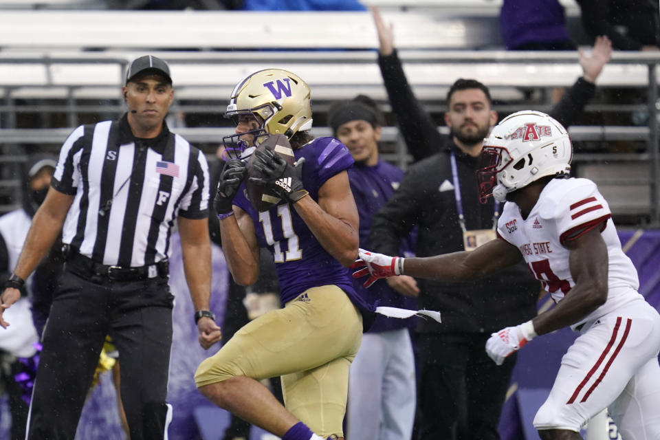 Washington's Jalen McMillan (11) scores on a 33-yard pass reception as Arkansas State's Denzel Blackwell defends in the first half of an NCAA college football game, Saturday, Sept. 18, 2021, in Seattle. (AP Photo/Elaine Thompson)