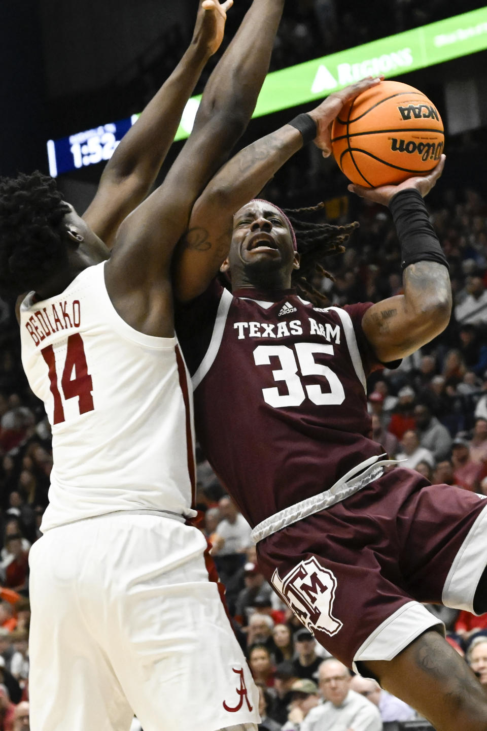 Texas A&M guard Manny Obaseki (35) shoots as Alabama center Charles Bediako (14) defends during the second half of an NCAA college basketball game in the finals of the Southeastern Conference Tournament, Sunday, March 12, 2023, in Nashville, Tenn. (AP Photo/John Amis)