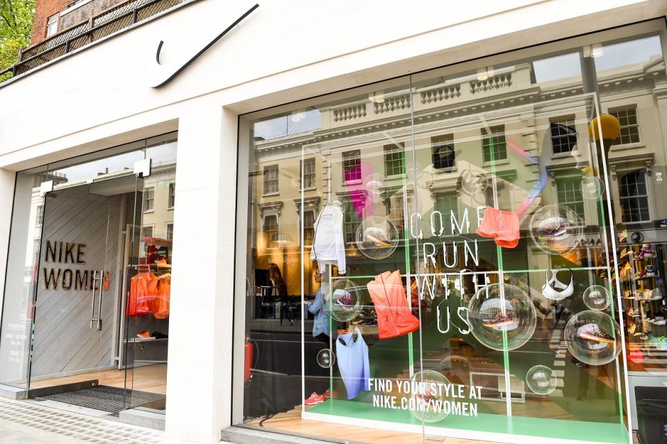 Nike Women store as seen from outside, with window display full of apparel and shoes.