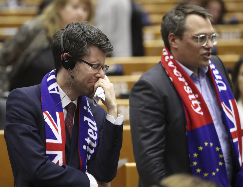 MEP's wear banners and react after a vote on the UK's withdrawal from the EU, the final legislative step in the Brexit proceedings, during the plenary session at the European Parliament in Brussels, Wednesday, Jan. 29, 2020. The U.K. is due to leave the EU on Friday, Jan. 31, 2020, the first nation in the bloc to do so. (Yves Herman, Pool Photo via AP)