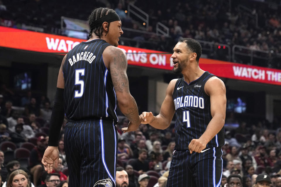 Orlando Magic's Paolo Banchero (5) and Jalen Suggs celebrate during the first half of the team's preseason NBA basketball game against the Cleveland Cavaliers, Thursday, Oct. 12, 2023, in Cleveland. (AP Photo/Sue Ogrocki)