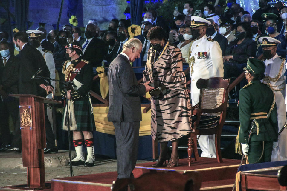 FILE - Barbados' new President Sandra Mason, center right, awards Prince Charles with the Order of Freedom of Barbados, during the presidential inauguration ceremony in Bridgetown, Barbados on Tuesday Nov. 30, 2021. After seven decades on the throne, Queen Elizabeth II is widely viewed in the U.K. as a rock in turbulent times. But in Britain’s former colonies, many see her as an anchor to an imperial past whose damage still lingers. (AP Photo/David McD Crichlow, File)