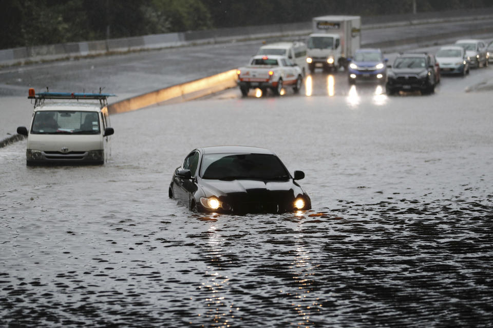 Vehicles are stranded by flood water in Auckland, Saturday, Jan 28, 2023. Record levels of rainfall pounded New Zealand's largest city, causing widespread disruption. (Dean Purcell/New Zealand Herald via AP)