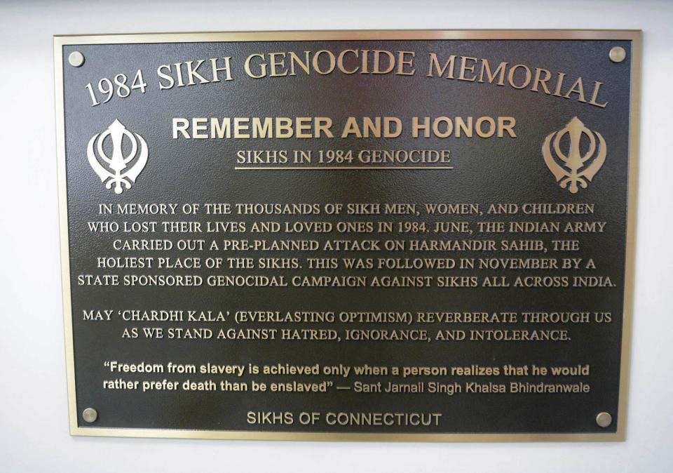 This May, 29, 2019 photo shows he newly installed 1984 Sikh Genocide Memorial plaque at Otis Library in Norwich, Conn. The Connecticut library has removed the memorial to Sikhs killed in India 35 years ago after a protest call from the Indian Consulate in New York. (John Shishmanian/NorwichBulletin.com via AP)