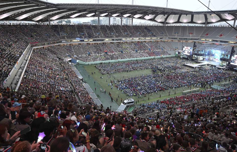 Attendees of the World Scout Jamboree watch a K-Pop concert after the closing ceremony of the World Scout Jamboree at the World Cup Stadium in Seoul, South Korea, Friday, Aug. 11, 2023. Flights and trains resumed and power was mostly restored Friday after a tropical storm blew through South Korea, which was preparing a pop concert for 40,000 Scouts whose global Jamboree was disrupted by the weather. (Korea Pool via AP)