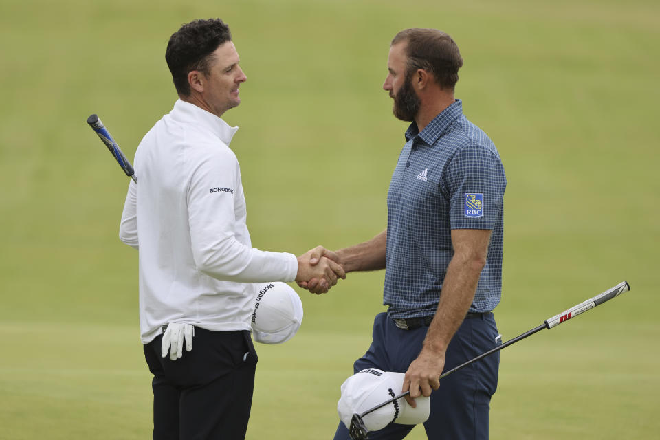 England's Justin Rose, left shakes hands with United States' Justin Rose after they completed their first round in the British Open Golf Championship at Royal St George's golf course Sandwich, England, Thursday, July 15, 2021. (AP Photo/Ian Walton)