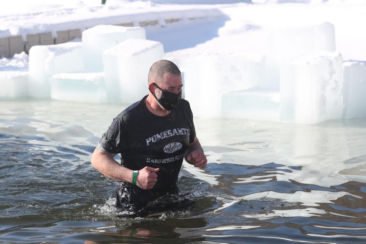 Participants in the 23rd annual  Fishkill Polar Plunge jump into the chilly waters of Sharp Reservoir at Camp Mariah in Fishkill Feb. 20, 2021. The Fishkill Polar Plunge raises funds for Special Olympics New York athletes in the Hudson Valley Region.