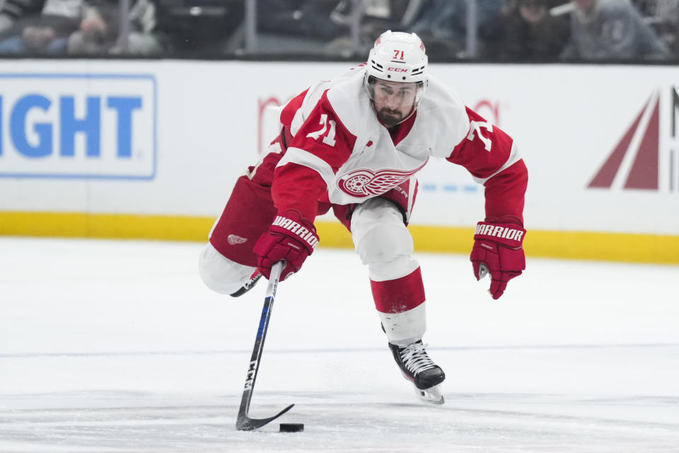 Detroit Red Wings center Dylan Larkin (71) reaches for the puck during the first period of the team's NHL hockey game against the Los Angeles Kings on Thursday, Jan. 4, 2024, in Los Angeles. (AP Photo/Jae C. Hong)