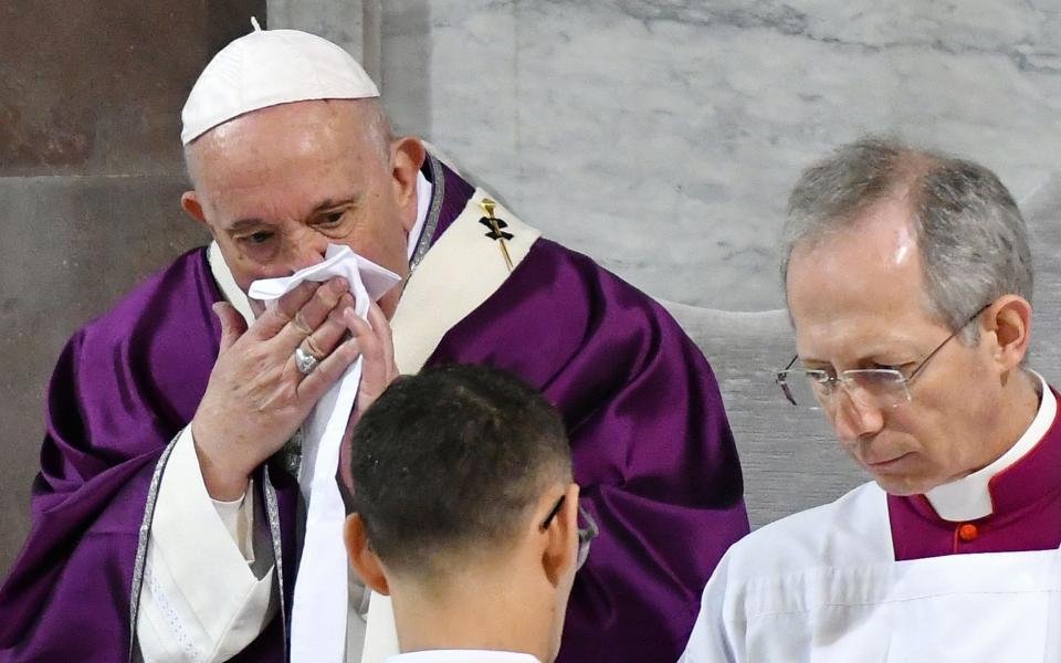 Pope Francis was seen wiping his nose and coughing during an Ash Wednesday service last week - Alberto Pizzoli/AFP