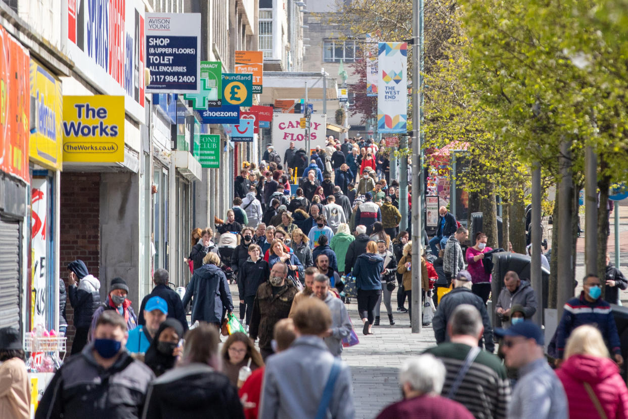 PLYMOUTH, ENGLAND - APRIL 12: Shoppers walking through the City Centre on April 12, 2021 in Plymouth, United Kingdom. England has taken a significant step in easing its lockdown restrictions, with non-essential retail, beauty services, gyms and outdoor entertainment venues among the businesses given the green light to re-open with coronavirus precautions in place. Pubs and restaurants are also allowed to open their outdoor areas, with no requirements for patrons to order food when buying alcoholic drinks. (Photo by William Dax/Getty Images)