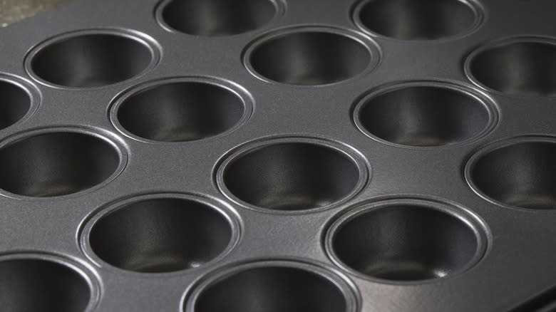 Empty muffin tin as background