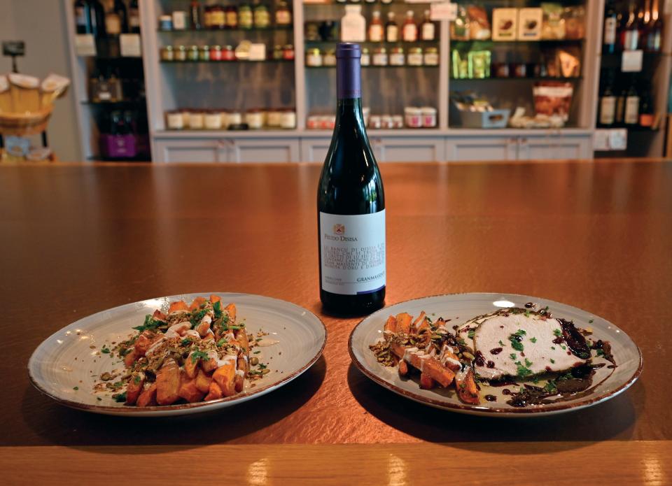 Roasted carrots with maple yogurt and pumpkin seed granola, left, served with herb encrusted pork loin with red wine fig reduction, right.