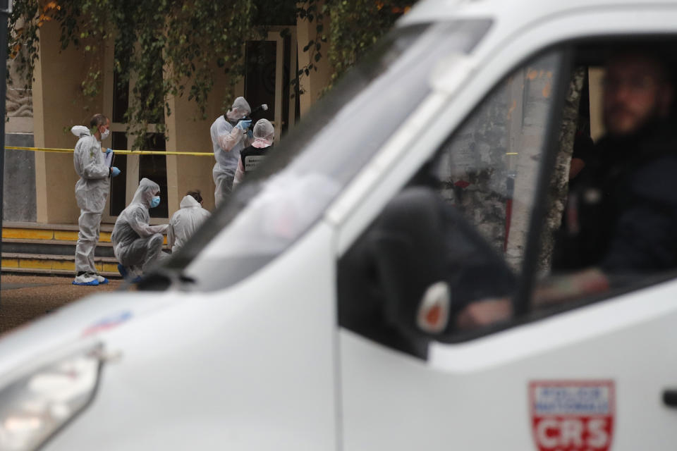 French forensic police officers work after a man armed with a knife killed a teacher and wounded two others at a high school in northern France, Friday, Oct. 13, 2023 in Arras. Antiterror prosecutors said they were leading the investigation into the attack at the Gambetta high school in the city of Arras, some 115 miles (185 kilometers) north of Paris. (AP Photo/Michel Spingler)