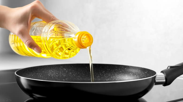 Pouring oil into a pan