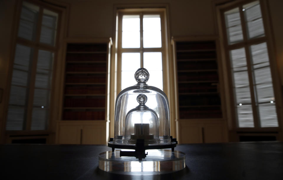 In this photo taken Wednesday, Oct. 17, 2018., a replica of the International Prototype Kilogram is pictured at the International Bureau of Weights and Measures, in Sevres, near Paris. The golf ball-sized metal cylinder at the heart of the world's system for measuring mass is heading into retirement. Gathering this week in Versailles, west of Paris, governments on Friday Nov. 16, 2018, are expected to approve a plan to instead use a scientific formula to define the exact weight of a kilo. (AP Photo/Christophe Ena)