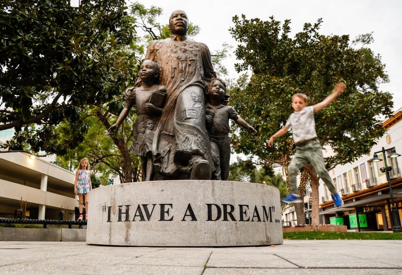 A youngster leaps off the Martin Luther King "I Have a Dream" statue