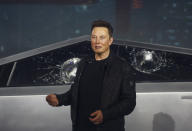 FILE - In this Nov. 21, 2019 file photo, Tesla CEO Elon Musk introduces the Cybertruck at Tesla's design studio in Hawthorne, Calif. Musk is taking on the workhorse heavy pickup truck market with his latest electric vehicle. The much-hyped unveil of Tesla’s electric pickup truck went off script Thursday night when supposedly unbreakable window glass shattered twice when hit with a large metal ball. The failed stunt, which ranks high on the list of embarrassing auto industry rollouts, came just after Musk bragged about the strength of “Tesla Armor Glass” on the wedge-shaped “Cybertruck.” (AP Photo/Ringo H.W. Chiu, File)