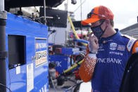 Scott Dixon, of New Zealand, looks at the results from a practice session for an IndyCar auto race at Indianapolis Motor Speedway, Thursday, Oct. 1, 2020, in Indianapolis. (AP Photo/Darron Cummings)
