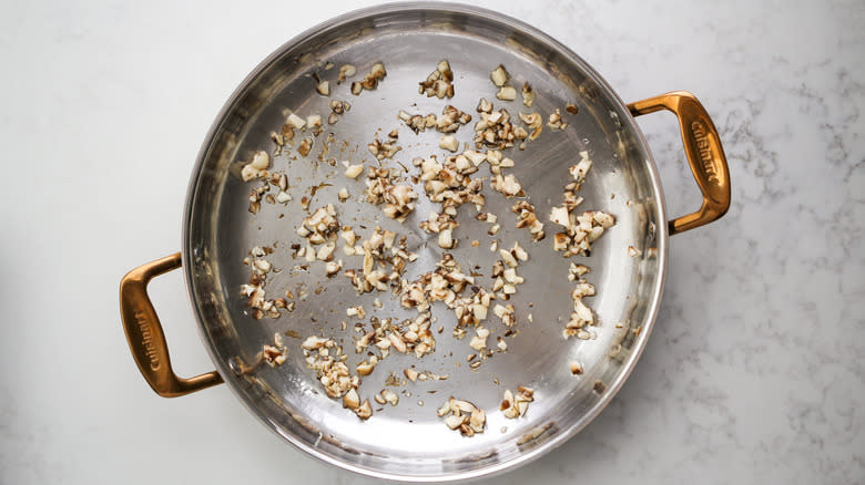 sauteeing diced mushrooms in pan