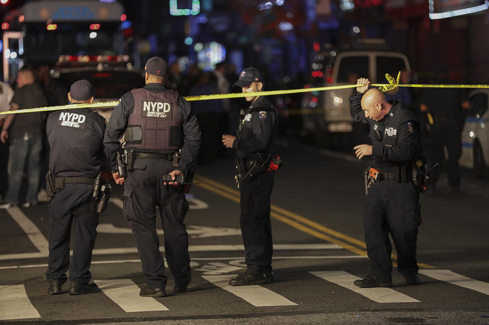 New York Police investigate the scene of a shooting where two police officers were injured and one person was shot, Friday, Oct. 25, 2019, in the Brownsville neighborhood of the Brooklyn borough of New York. (AP Photo/Julius Motal)