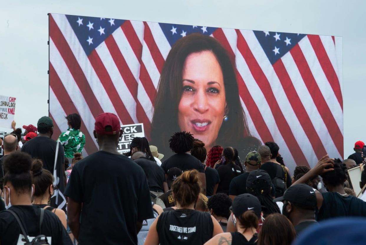 <span class="caption">Kamala Harris speaking via a screen to demonstrators at the protest against racism and police brutality on Aug. 28, 2020, in Washington, D.C. </span> <span class="attribution"><a class="link " href="https://www.gettyimages.com/detail/news-photo/demonstrators-watch-democratic-vice-presidential-nominee-news-photo/1228243557?adppopup=true" rel="nofollow noopener" target="_blank" data-ylk="slk:Roberto Schmidt/AFP via Getty Images);elm:context_link;itc:0;sec:content-canvas">Roberto Schmidt/AFP via Getty Images)</a></span>