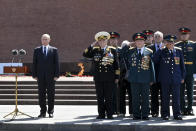 Russian President Vladimir Putin, left, stand, prior to delivering his speech, next to a small group of Russian WWII veterans during a wreath laying ceremony, at the Tomb of Unknown Soldier in Moscow, Russia, Tuesday, June 22, 2021, marking the 80th anniversary of the Nazi invasion of the Soviet Union. (Alexei Nikolsky, Sputnik, Kremlin Pool Photo via AP)