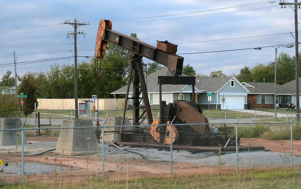 An oil well pumpjack is shown near homes on NE 8 at Martin Luther King Avenue.