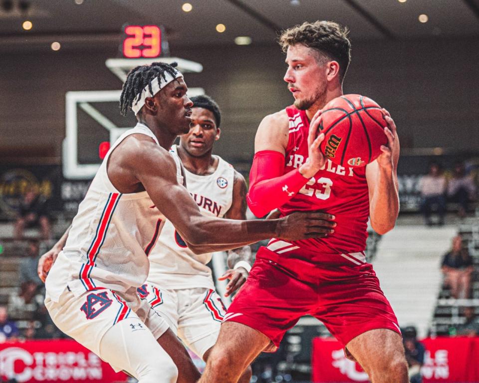 An Auburn defender grabs Bradley guard Ville Tahvanainen by the shirt during BU's 85-64 loss in the 2022 Cancun Challenge on Tuesday, Nov. 22, 2022 at Hard Rock Hotel Riviera Maya in Cancun, Mexico.