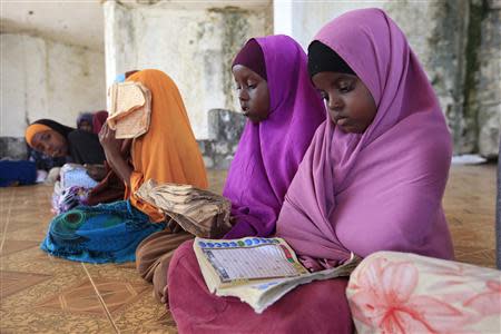 Children read during a Koranic studies lesson inside a classroom in the Hodan area of Mogadishu September 25, 2013. REUTERS/Feisal Omar