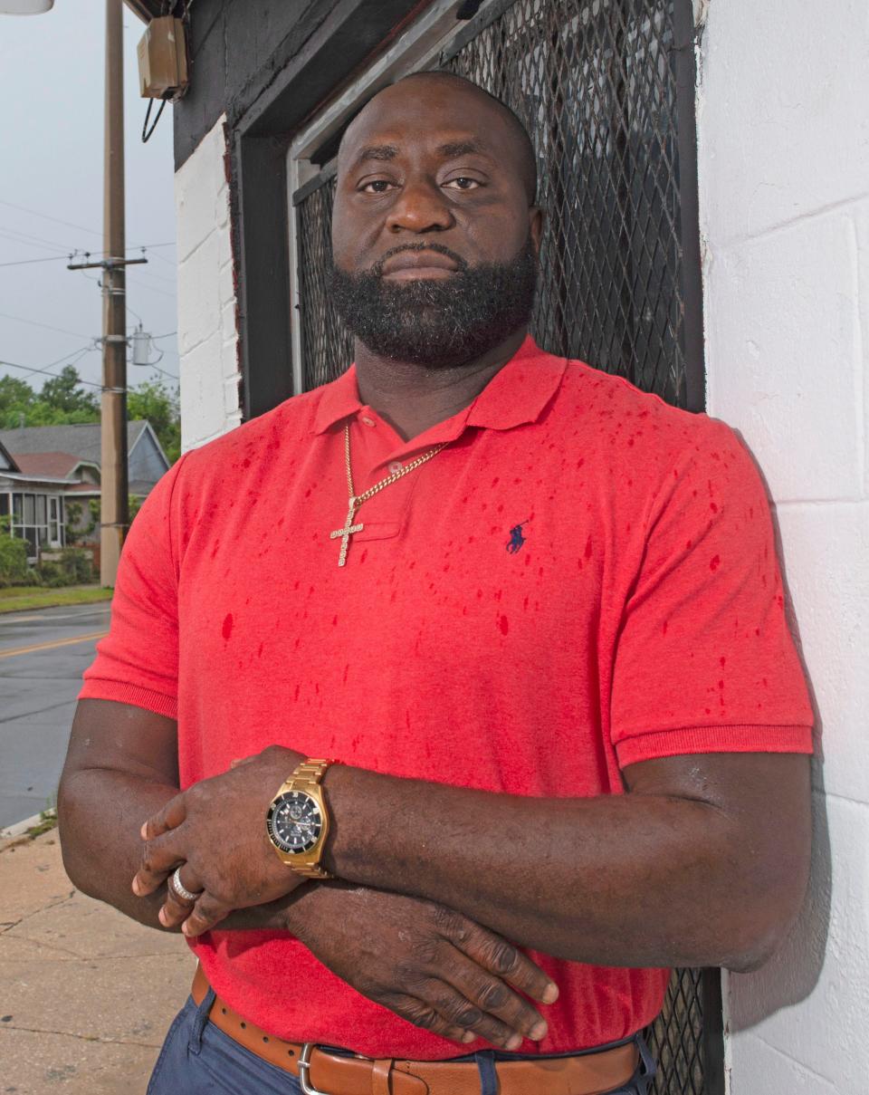 Hassan Hills, founder of the new nonprofit Youths Left Behind Corp., stands on the corner of the A and Jackson streets in Pensacola where in his own youth he sold drugs. He's now working to empower the community that he says he once "helped to destory."