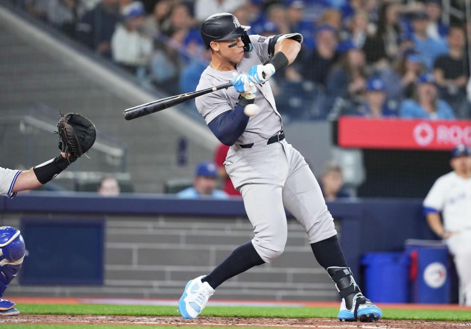 Apr 15, 2024; Toronto, Ontario, CAN; New York Yankees outfielder Aaron Judge wearing number 42 for Jackie Robinson Day gets an inside pitch against the Toronto Blue Jays during the third inning at Rogers Centre. Mandatory Credit: Nick Turchiaro-USA TODAY Sports