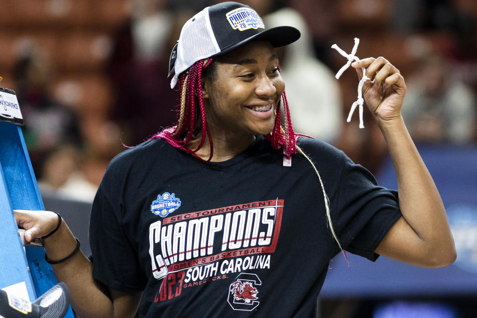 FILE - South Carolina's Aliyah Boston holds up her piece of the the net after defeating Tennessee 74-58 to win the championship game of the Southeastern Conference women's tournament in Greenville, S.C., Sunday, March 5, 2023. (AP Photo/Mic Smith, File)
